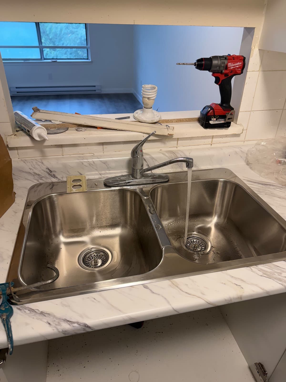 New double stainless steel kitchen sink and faucet with water running